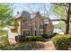 A charming brick home with manicured landscaping, a well-maintained lawn, and mature trees at 482 Cooper Lake Se Rd, Smyrna, GA 30126