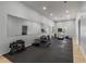 Home gym with mirrors, rubber flooring, and a variety of exercise equipment at 482 Cooper Lake Se Rd, Smyrna, GA 30126