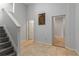 Tiled hallway featuring staircase, light gray walls, and doorways to other rooms at 482 Cooper Lake Se Rd, Smyrna, GA 30126