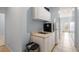 Hallway featuring kitchenette with mini fridge and sink, leading to an outdoor patio at 482 Cooper Lake Se Rd, Smyrna, GA 30126