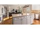 Kitchen island has stone countertop, stainless dishwasher, and white cabinets with an adjacent living room at 482 Cooper Lake Se Rd, Smyrna, GA 30126