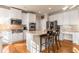 Bright kitchen with white cabinets, stainless steel appliances, and a central island with seating at 482 Cooper Lake Se Rd, Smyrna, GA 30126
