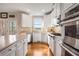 Modern kitchen features stainless steel appliances, white cabinets, tiled backsplash, and hardwood floors at 482 Cooper Lake Se Rd, Smyrna, GA 30126