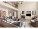 Spacious living room with fireplace, plush seating, and natural light from high windows at 482 Cooper Lake Se Rd, Smyrna, GA 30126