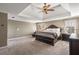 Spacious main bedroom with tray ceiling, ceiling fan, and carpet flooring at 482 Cooper Lake Se Rd, Smyrna, GA 30126