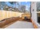 Cozy backyard with privacy fence and concrete patio featuring retaining wall at 1016 Rose Dr, Marietta, GA 30060