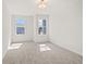 Bedroom featuring neutral carpet and walls with sunny views from two windows at 1016 Rose Dr, Marietta, GA 30060