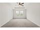 Spacious bedroom with neutral carpet, tray ceilings with a ceiling fan, and ample natural light at 1016 Rose Dr, Marietta, GA 30060