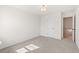 Bedroom featuring neutral carpet and walls with an open door showing a staircase at 1016 Rose Dr, Marietta, GA 30060
