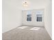 Sunlit bedroom with two windows and neutral carpeting at 1016 Rose Dr, Marietta, GA 30060