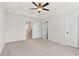 Spacious bedroom featuring neutral walls, plush carpeting, a ceiling fan, and ample closet space at 1016 Rose Dr, Marietta, GA 30060