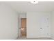 Cozy bedroom with neutral carpet and walls, with an open door showing a staircase at 1016 Rose Dr, Marietta, GA 30060