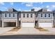 New townhome with brick and siding, featuring attached garages and professional landscaping at 1016 Rose Dr, Marietta, GA 30060