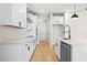 Modern kitchen featuring white cabinets, stainless steel appliances, and a stylish island with a black faucet at 1016 Rose Dr, Marietta, GA 30060