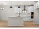 Modern kitchen with white cabinets, a center island, and stainless steel appliances at 1016 Rose Dr, Marietta, GA 30060