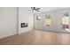 Bright living room featuring wood floors, a ceiling fan, a modern fireplace and access to backyard at 1016 Rose Dr, Marietta, GA 30060