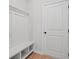 Mudroom area with a white storage bench and coat rack, providing an organized space by the door at 1016 Rose Dr, Marietta, GA 30060