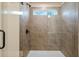 Newly tiled shower with seamless glass enclosure and a small picture window at 1016 Rose Dr, Marietta, GA 30060