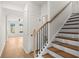 Open staircase with wood steps, black iron spindles, and a natural wood banister at 1016 Rose Dr, Marietta, GA 30060