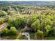 Aerial view showing a home nestled amongst mature trees creating a serene and private retreat at 1039 Smyrna Rd Sw, Conyers, GA 30094