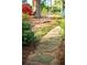 Backyard stone path with lush greenery leading to a serene outdoor space, perfect for relaxation at 1039 Smyrna Rd Sw, Conyers, GA 30094