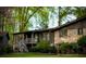 Lush backyard featuring a brick house with a screened porch, mature trees, and a well-maintained lawn at 1039 Smyrna Rd Sw, Conyers, GA 30094