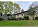 Spacious backyard featuring a well-maintained lawn and a two-story house with brick facade and lush landscaping at 1039 Smyrna Rd Sw, Conyers, GA 30094
