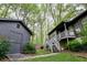 Exterior view showcasing a two-story deck and backyard shed against a backdrop of lush greenery at 1039 Smyrna Rd Sw, Conyers, GA 30094