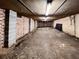 Unfinished basement featuring brick walls, exposed ceiling, and concrete support beams, offering potential for customization at 1039 Smyrna Rd Sw, Conyers, GA 30094