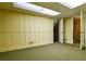 Basement featuring paneled walls and a doorway leading to upstairs at 1039 Smyrna Rd Sw, Conyers, GA 30094