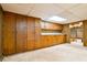 Basement area with built-in cabinets, countertop, and paneled walls, with a saloon style door at 1039 Smyrna Rd Sw, Conyers, GA 30094