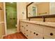 Bathroom with double sinks, granite countertops, and glass enclosed shower at 1039 Smyrna Rd Sw, Conyers, GA 30094