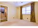 A bright bedroom with a large window dressed with floral curtains at 1039 Smyrna Rd Sw, Conyers, GA 30094