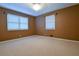 Simple bedroom with large window providing light, featuring carpet and neutral walls at 1039 Smyrna Rd Sw, Conyers, GA 30094