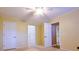 Cozy bedroom with two access doors, ceiling fan and light, and carpeted floor at 1039 Smyrna Rd Sw, Conyers, GA 30094