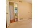 A bedroom with tan colored walls and carpet, with a closet and entry to additional rooms at 1039 Smyrna Rd Sw, Conyers, GA 30094