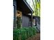 Home exterior featuring climbing ivy, lantern style lighting, and a side entrance at 1039 Smyrna Rd Sw, Conyers, GA 30094