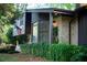 Exterior shot of home featuring brick facade, climbing ivy, and lush landscaping at 1039 Smyrna Rd Sw, Conyers, GA 30094