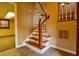 Tiled foyer area with staircase to the second story and partial view of the living room at 1039 Smyrna Rd Sw, Conyers, GA 30094