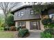 Two-story brick home with a decorative front door, mature trees and lush landscaping at 1039 Smyrna Rd Sw, Conyers, GA 30094