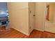 Hallway showing the transition from hardwood to patterned wallpaper and wainscotting at 1039 Smyrna Rd Sw, Conyers, GA 30094