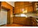 Kitchen with wooden cabinets and trim, granite countertops and tile backsplash at 1039 Smyrna Rd Sw, Conyers, GA 30094