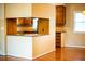 Kitchen features wood cabinets, granite countertops, and access to the living room at 1039 Smyrna Rd Sw, Conyers, GA 30094