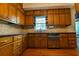 Kitchen with stainless steel appliances, wood cabinets, hardwood floors, and granite countertops at 1039 Smyrna Rd Sw, Conyers, GA 30094
