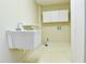 Utility room equipped with a sink, cabinets, and hookups for laundry appliances at 1039 Smyrna Rd Sw, Conyers, GA 30094