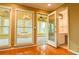 Bright living room showcasing hardwood floors, windows, and access to the sunroom and bathroom at 1039 Smyrna Rd Sw, Conyers, GA 30094