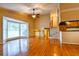 Bright living room with hardwood floors, large windows, and staircase to second floor at 1039 Smyrna Rd Sw, Conyers, GA 30094