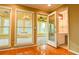 Bright living room showcasing hardwood floors, windows, and access to the sunroom and bathroom at 1039 Smyrna Rd Sw, Conyers, GA 30094