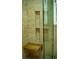 This is a shower with a wooden seat and tiled walls, built in cubbies and glass door at 1039 Smyrna Rd Sw, Conyers, GA 30094