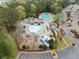 Aerial view of a community pool area with multiple pools, play areas, and well-maintained landscaping at 13070 Tidewater Xing, Alpharetta, GA 30005